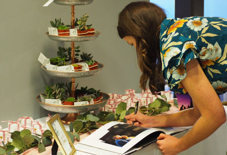 Signing the guest book at a wedding shower at the Sigal Museum.